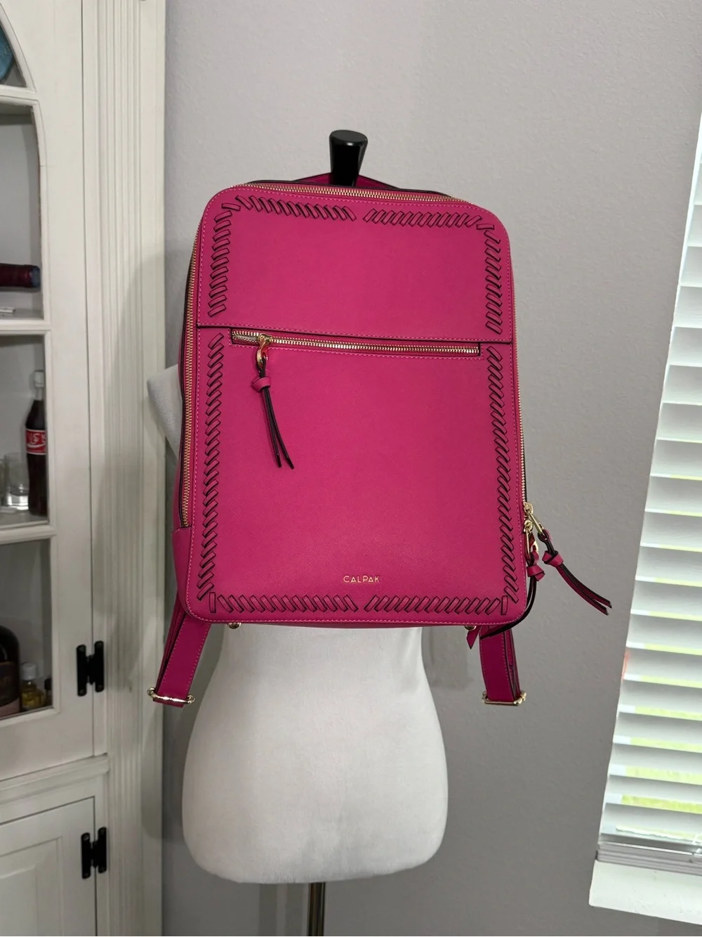 CALPAK Kaya Laptop Backpack in the vibrant Dragonfruit hot pink